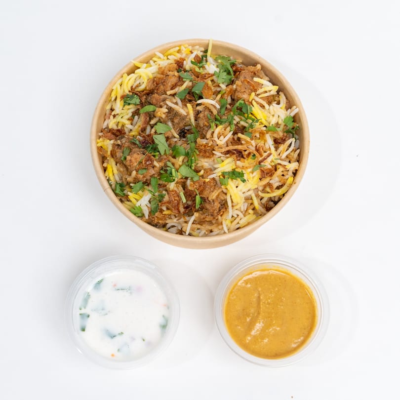 H1B - Hyderabad No1 Biryani: Chicken biryani with rice, fried onions, cilantro, and two sauces.