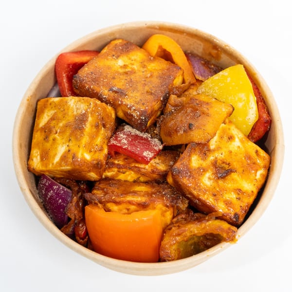 H1B's Paneer 65, featuring golden-brown paneer cubes with colorful bell peppers and onions in a bowl.