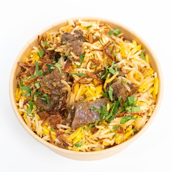 A close-up of Hyderabad No1 Biryani with meat, rice, fried onions, and cilantro in a bowl.